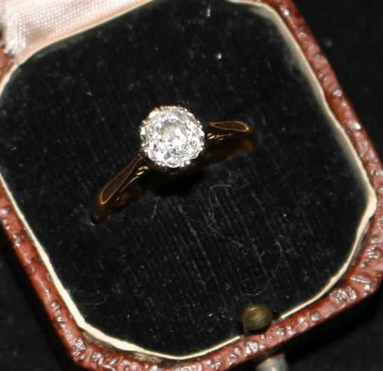 An early 20th century 18ct gold and platinum solitaire diamond ring, size O.